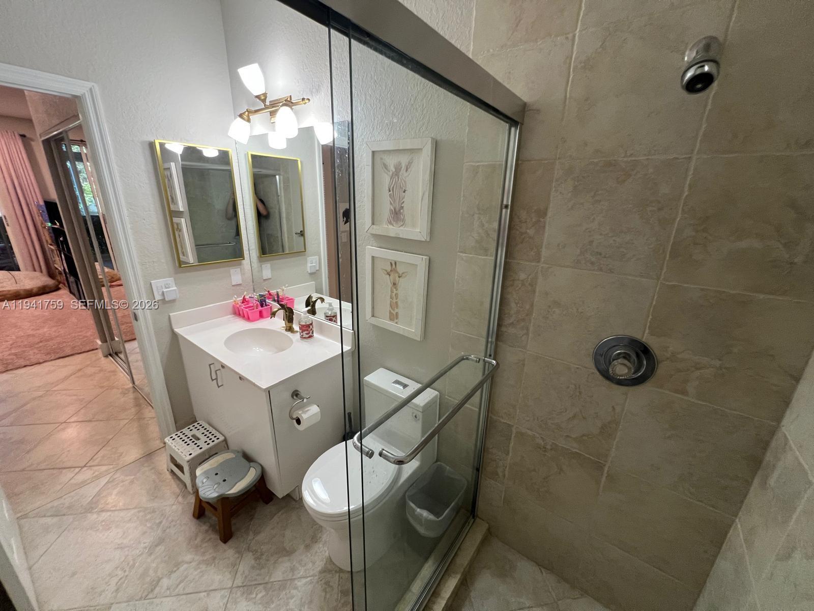 75 Gulfstream Road, Unit 211B Dania Beach, FL 33004 - Photo 26 of 57 a bathroom with a sink mirror and shower