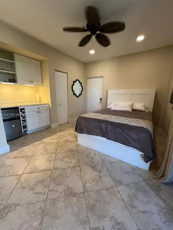 a spacious bedroom with a bed and a view of bathroom
