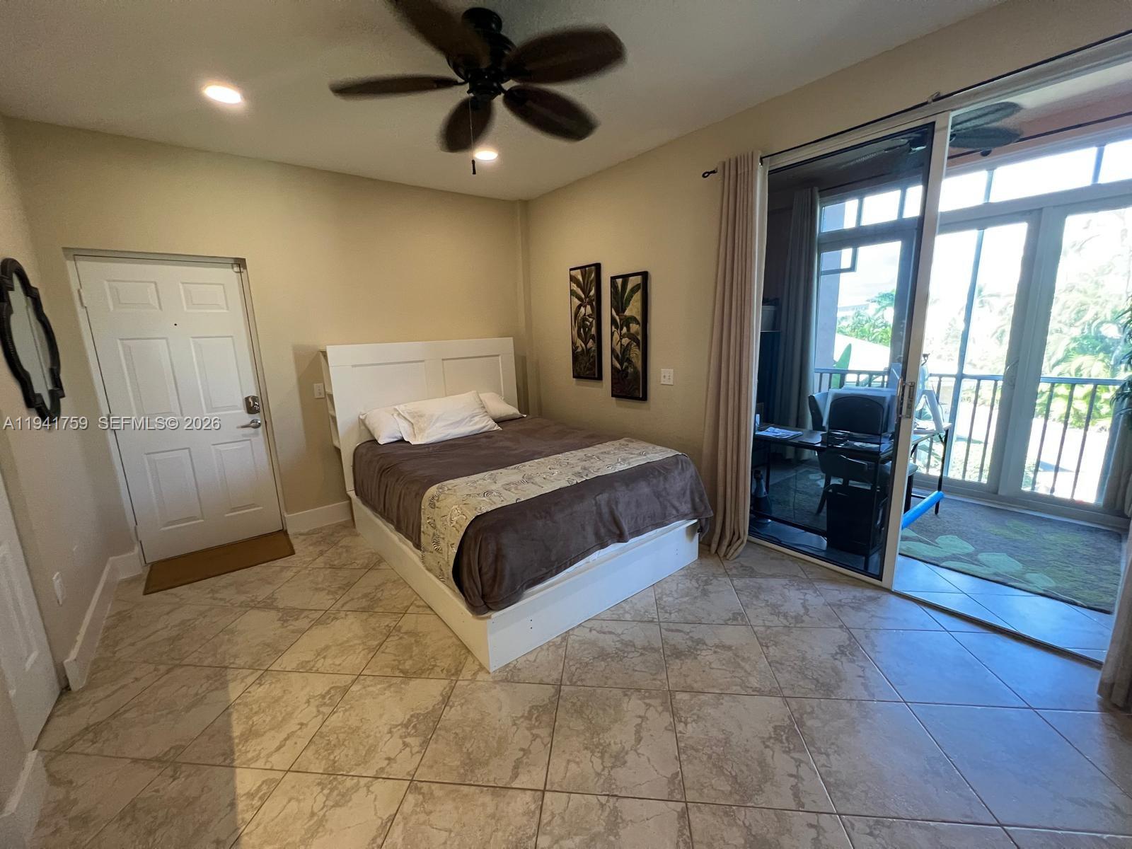 75 Gulfstream Road, Unit 211B Dania Beach, FL 33004 - Photo 29 of 57 a spacious bedroom with a bed and a view of bathroom