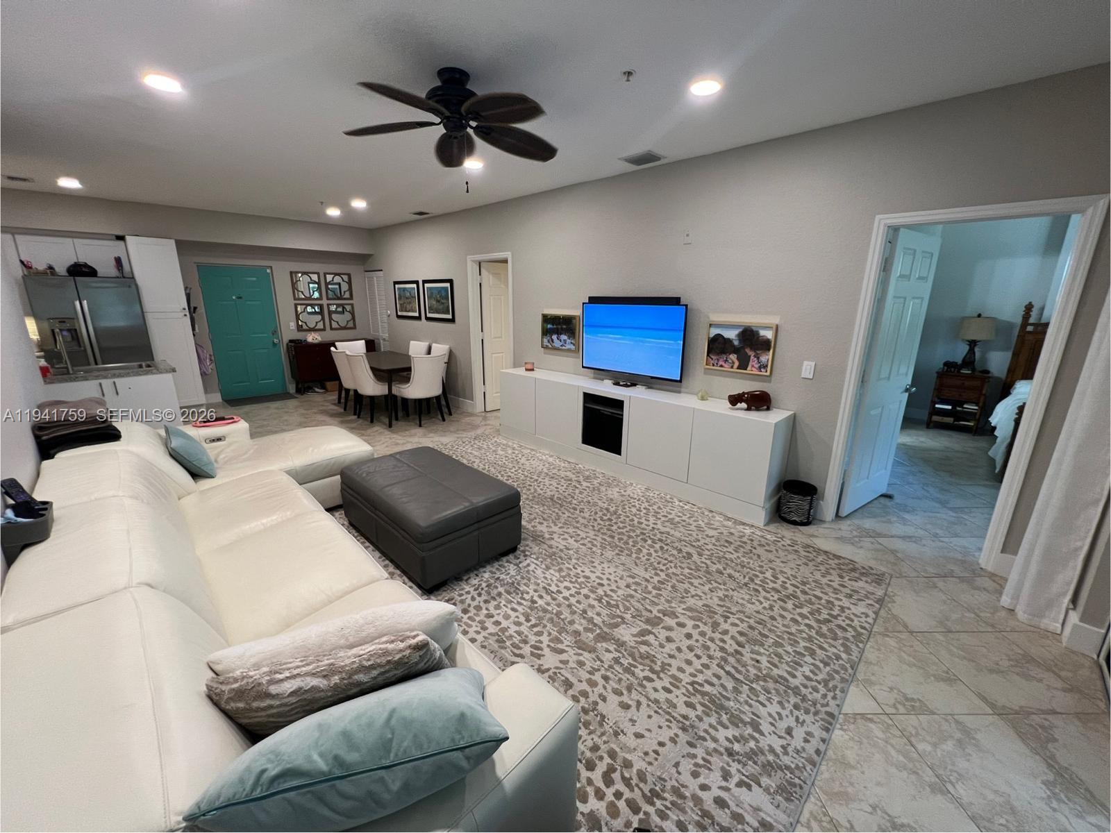 75 Gulfstream Road, Unit 211B Dania Beach, FL 33004 - Photo 3 of 57 a living room with furniture and a flat screen tv