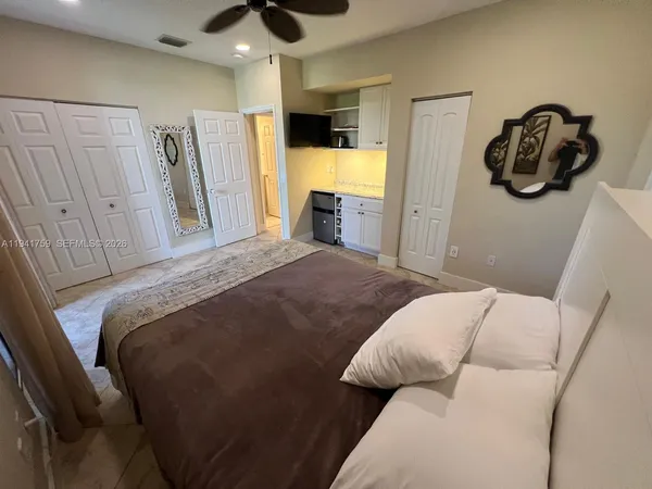 a bedroom with a bed and a walk in closet