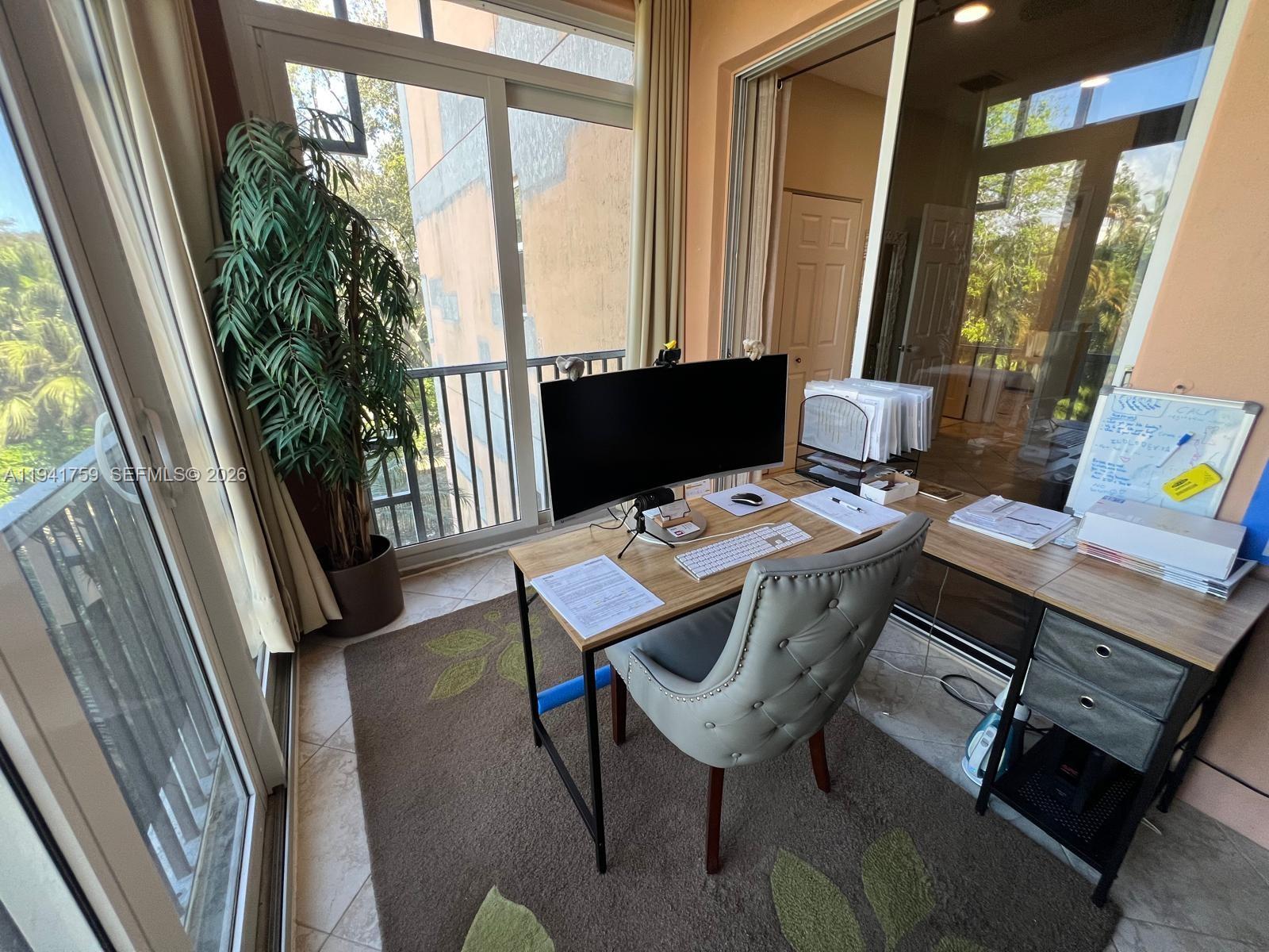 75 Gulfstream Road, Unit 211B Dania Beach, FL 33004 - Photo 33 of 57 a view of a workspace with furniture and a window