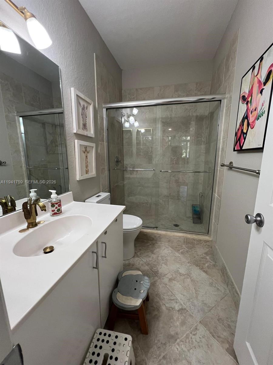 75 Gulfstream Road, Unit 211B Dania Beach, FL 33004 - Photo 35 of 57 a bathroom with a sink toilet and shower