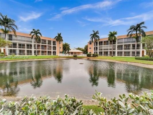 75 Gulfstream Road, Unit 211B Dania Beach, FL 33004 - Photo 41 of 57 a view of a lake with a building in the background