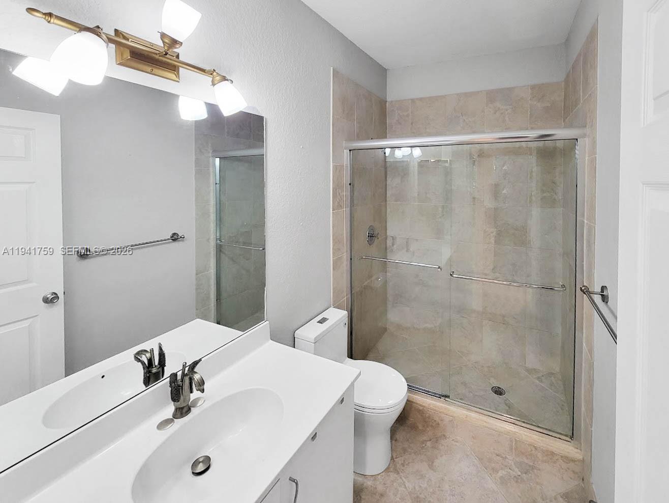 75 Gulfstream Road, Unit 211B Dania Beach, FL 33004 - Photo 46 of 57 a bathroom with a sink a toilet and shower