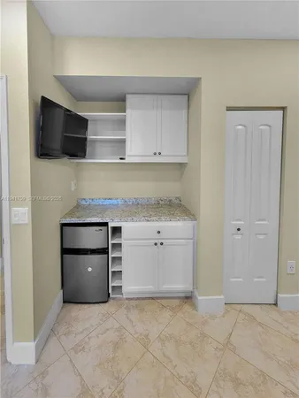 a large white kitchen with white cabinets