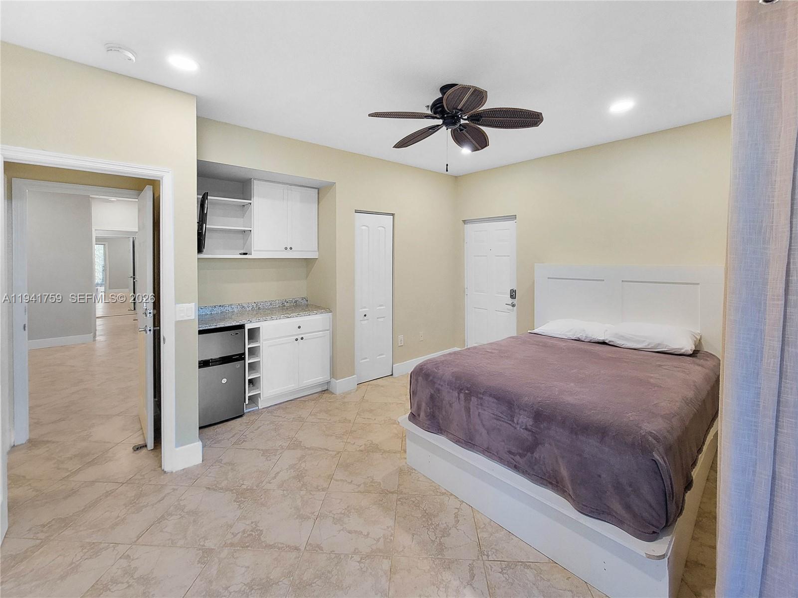 75 Gulfstream Road, Unit 211B Dania Beach, FL 33004 - Photo 51 of 57 a bedroom with a bed and a ceiling fan