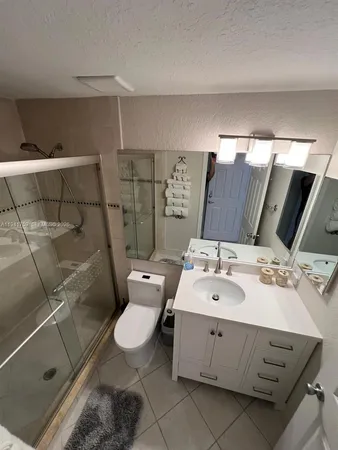 a bathroom with a double vanity sink mirror and toilet