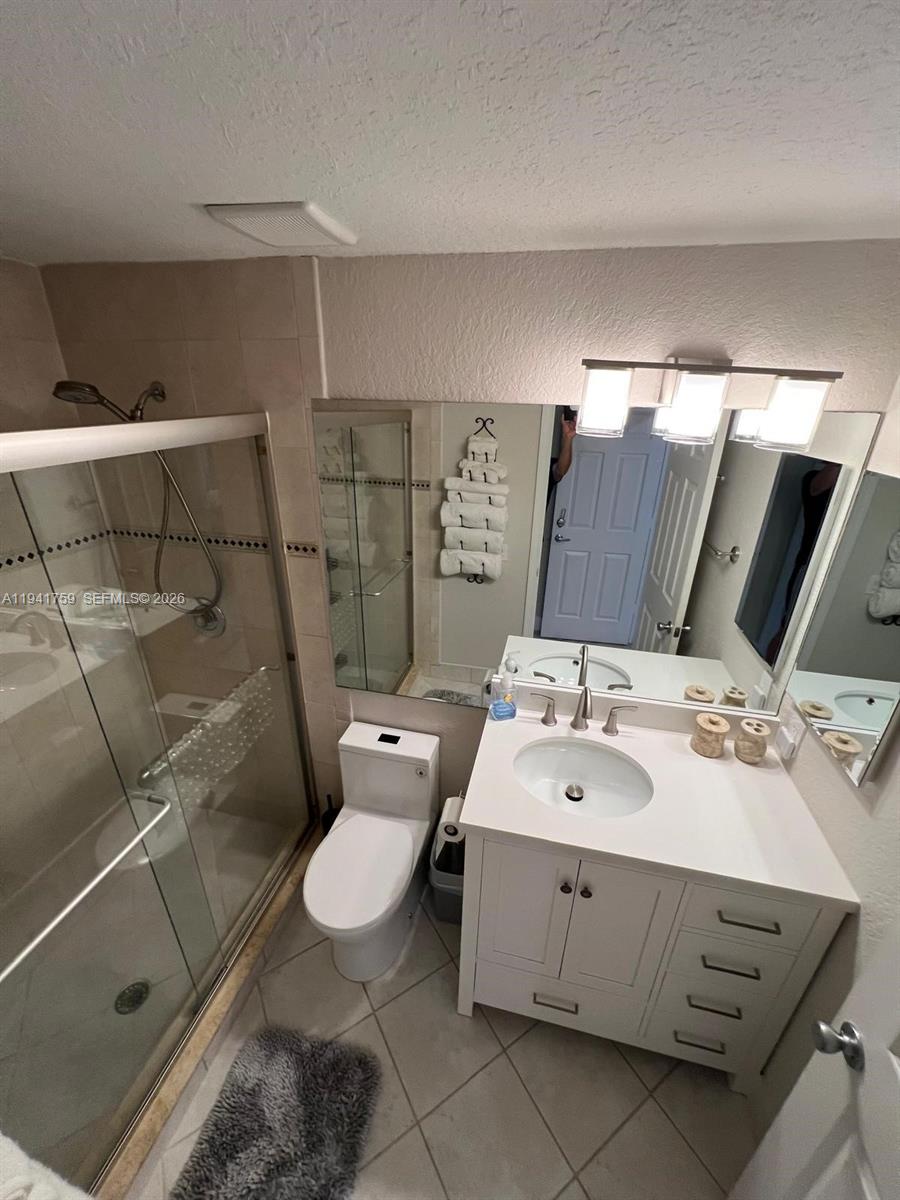 75 Gulfstream Road, Unit 211B Dania Beach, FL 33004 - Photo 8 of 57 a bathroom with a double vanity sink mirror and toilet