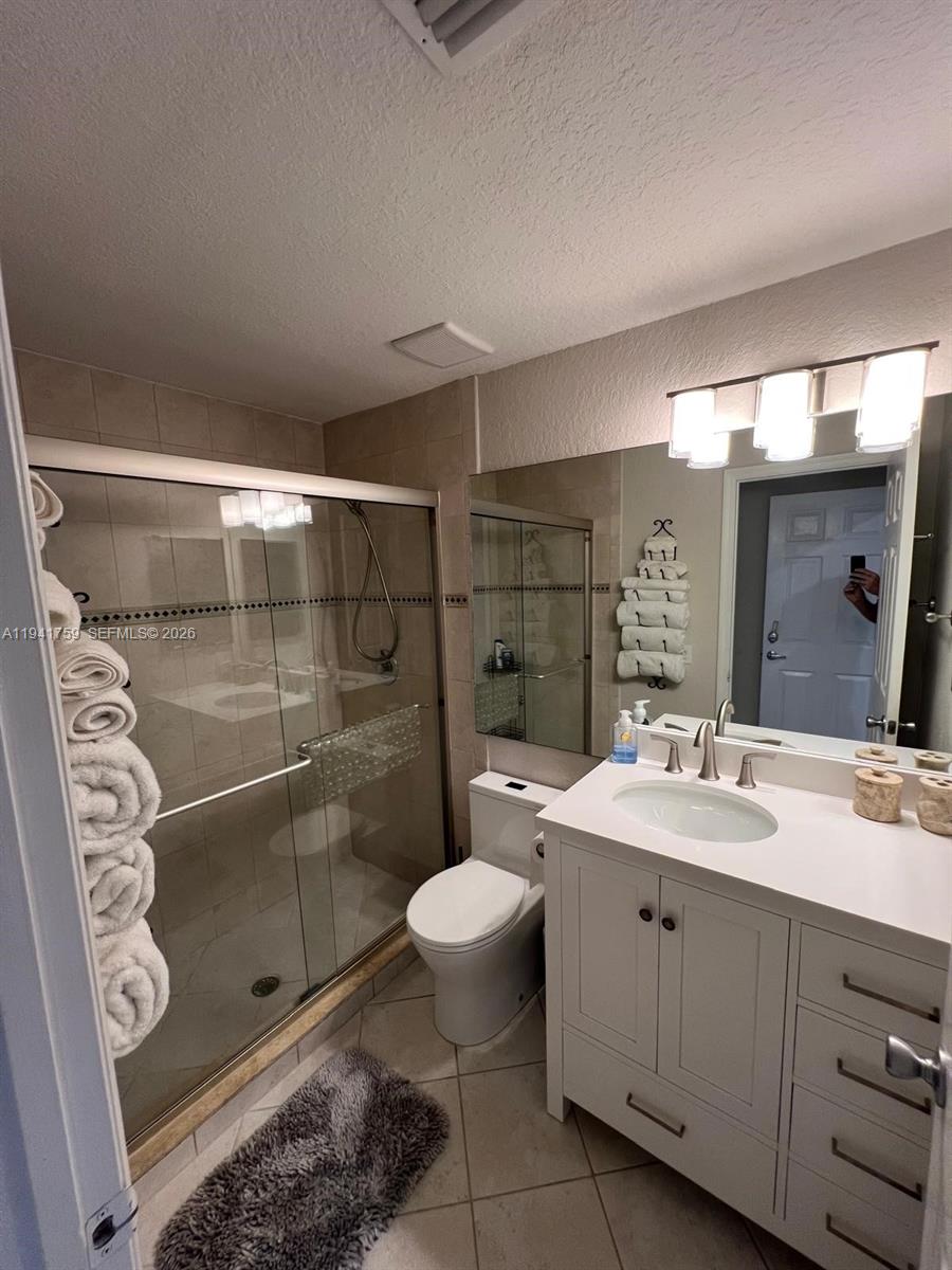 75 Gulfstream Road, Unit 211B Dania Beach, FL 33004 - Photo 9 of 57 a bathroom with a double vanity sink mirror and toilet