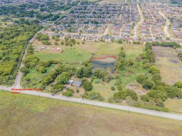 an aerial view of a residential houses with outdoor space