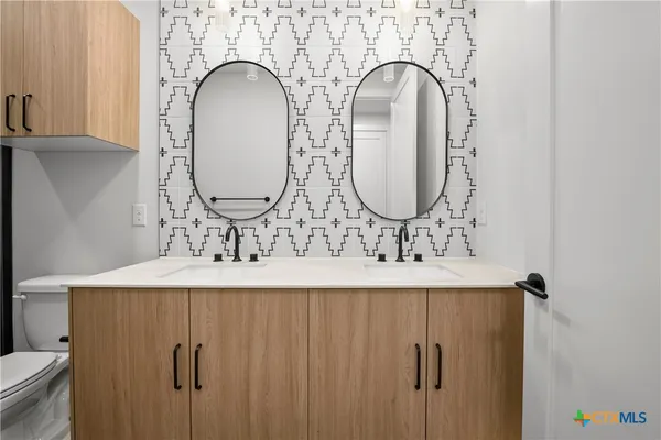 a bathroom with a sink and mirror