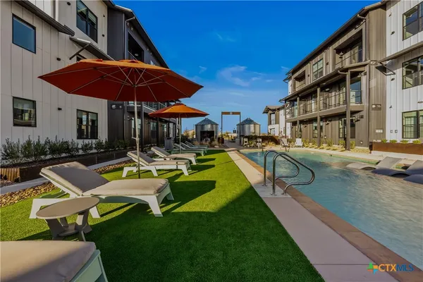 a front view of house with yard and outdoor seating