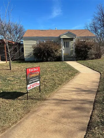 a sign board on the side of a building