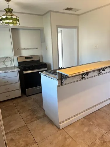 a kitchen with granite countertop a sink and a stove top oven