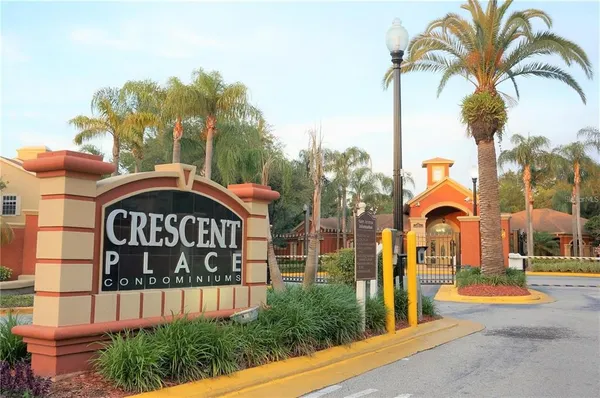 a front view of a house with a garden and a tree