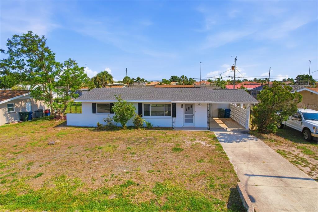 363 Glen Oak Road Venice, FL 34293 - Photo 4 of 53 a front view of a house with a yard