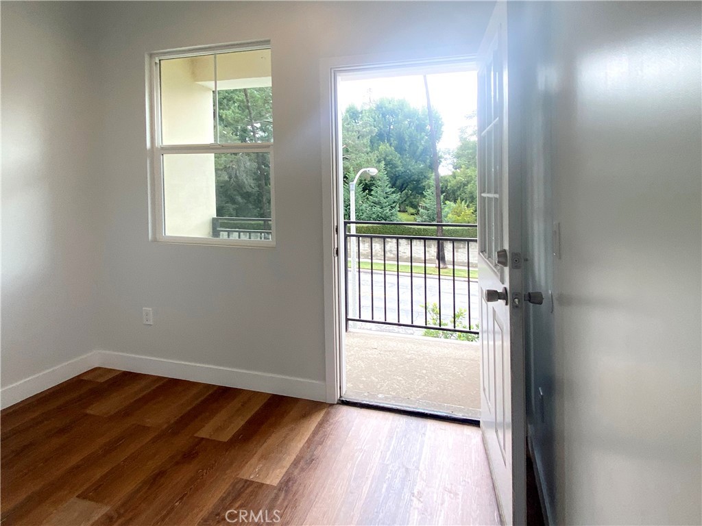 300 East Alhambra Road, Unit E Alhambra, CA 91801 - Photo 12 of 24 an empty room with wooden floor and windows