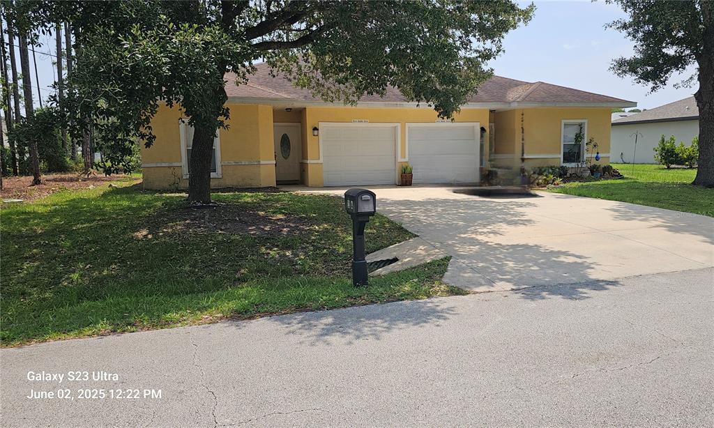 23 Riddle Drive, Unit A Palm Coast, FL 32164 - Photo 1 of 1 a front view of a house with a yard and garage