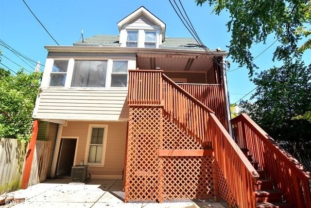 a view of a house with wooden deck front of house