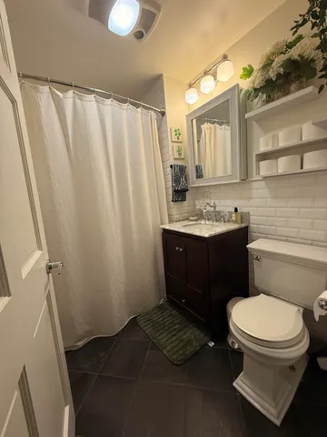 a bathroom with a toilet a sink and a mirror