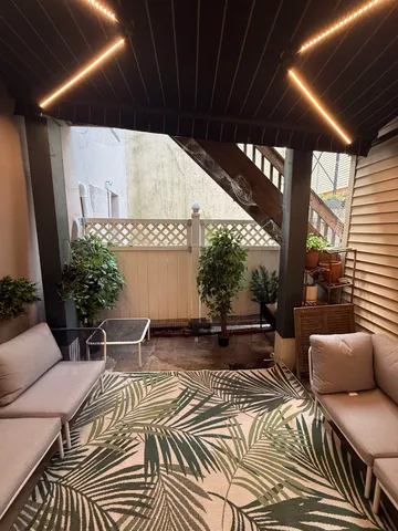 a balcony with furniture and potted plants