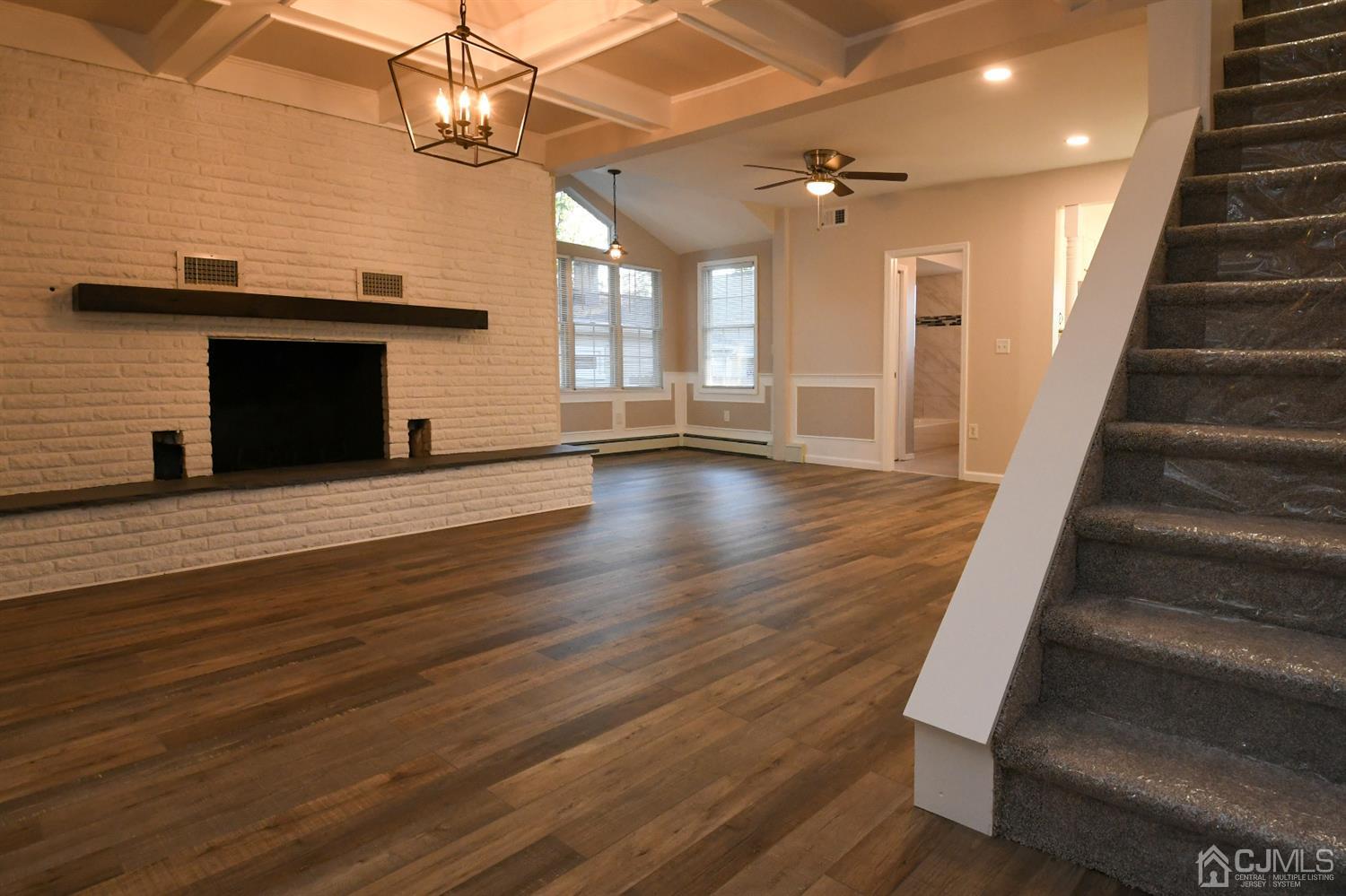 15 Brookside Road Spotswood, NJ 08884 - Photo 3 of 42 an empty room with wooden floor and a fireplace