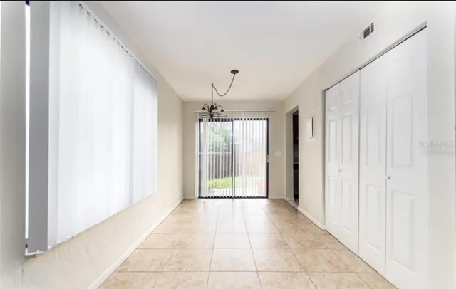 a view of a hallway with wooden shelves