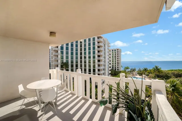 a balcony with table and chairs