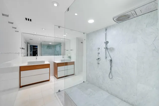 a bathroom with a tub sink shower and mirror