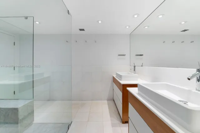 a spacious bathroom with a bathtub sink and mirror