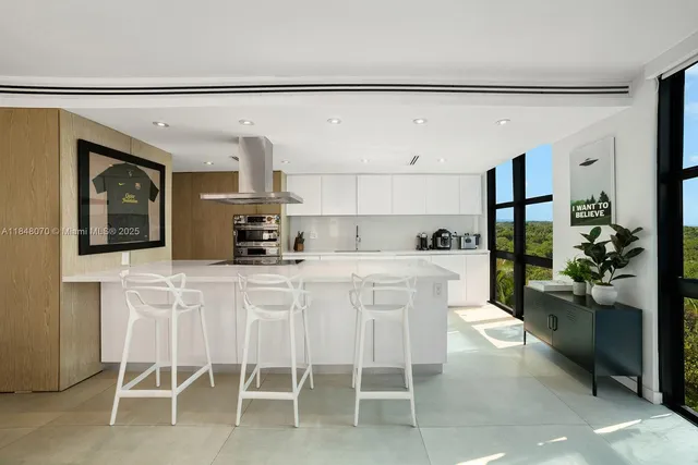 a kitchen with a sink and chairs