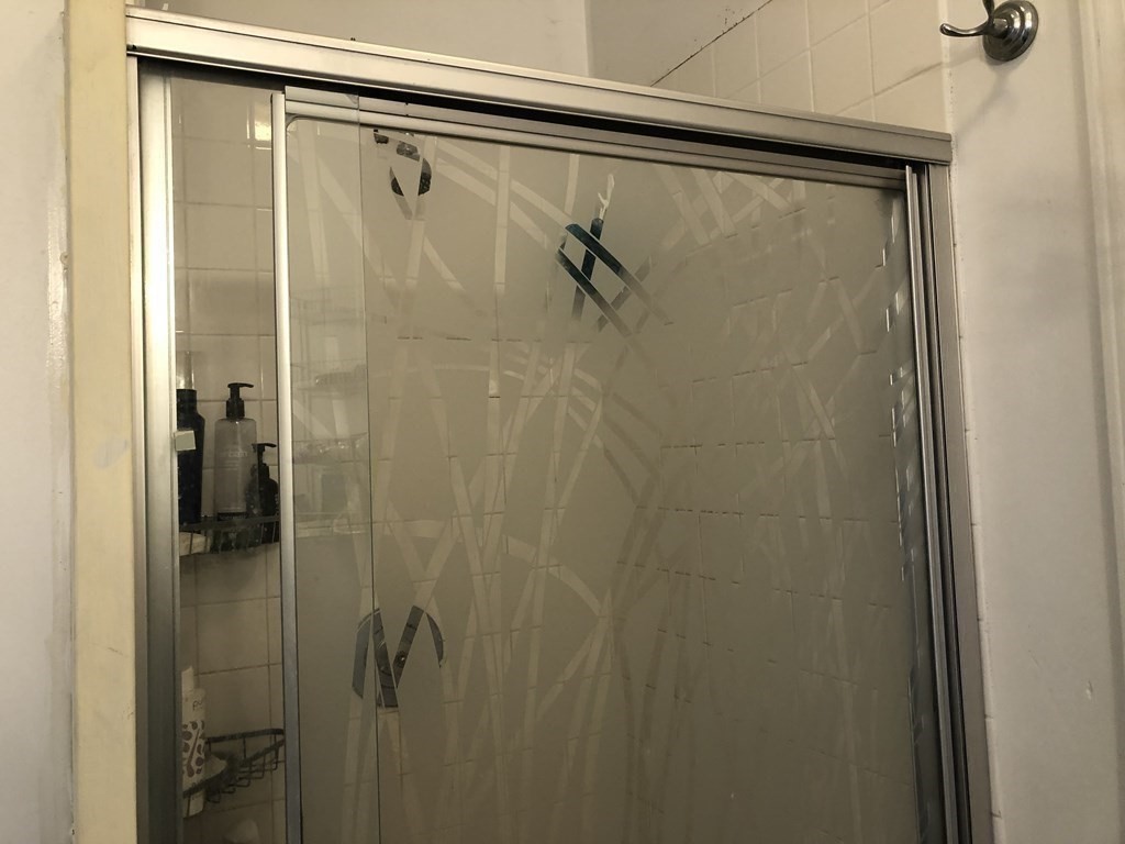 68 Boylston Street, Unit 4 Brookline, MA 02445 - Photo 11 of 12 a bathroom with a glass shower door
