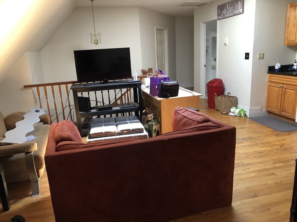 68 Boylston Street, Unit 4 Brookline, MA 02445 - Photo 2 of 12 a living room with furniture and a flat screen tv