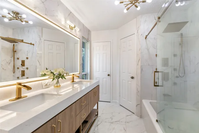 a spacious bathroom with a double vanity sink a large mirror and shower