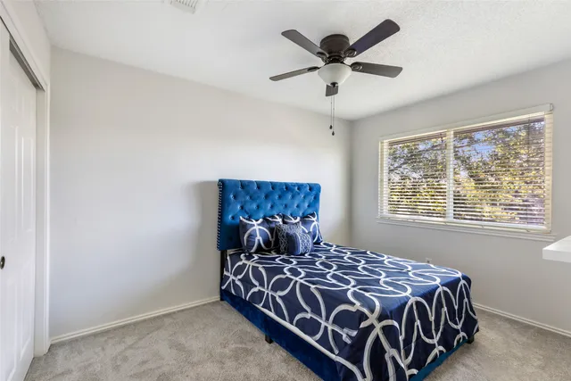 a bed sitting in a bedroom next to a window