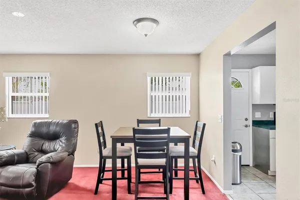 a dining room with furniture and window