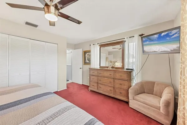 a bedroom with a bed and a couch