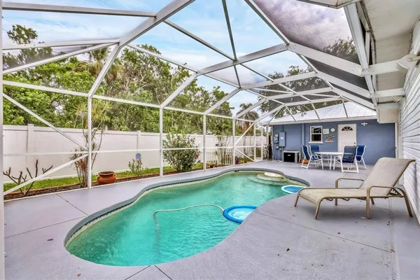 a view of a swimming pool with a yard