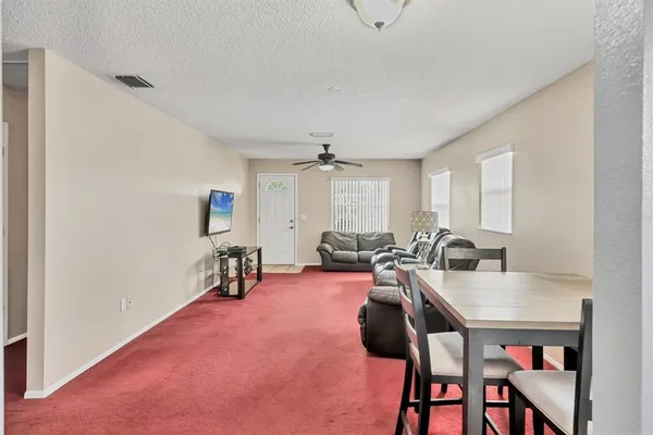 a living room with furniture a window and a table