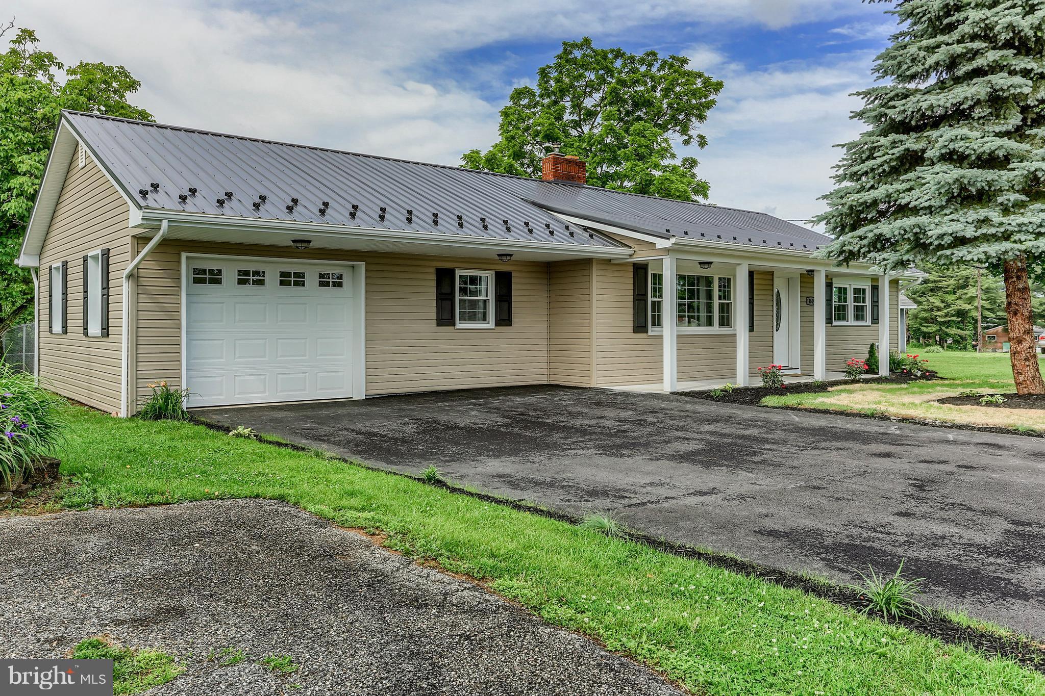 14809 Clear Spring Road Williamsport, MD 21795 - Photo 2 of 27 a front view of a house with a yard and a garage
