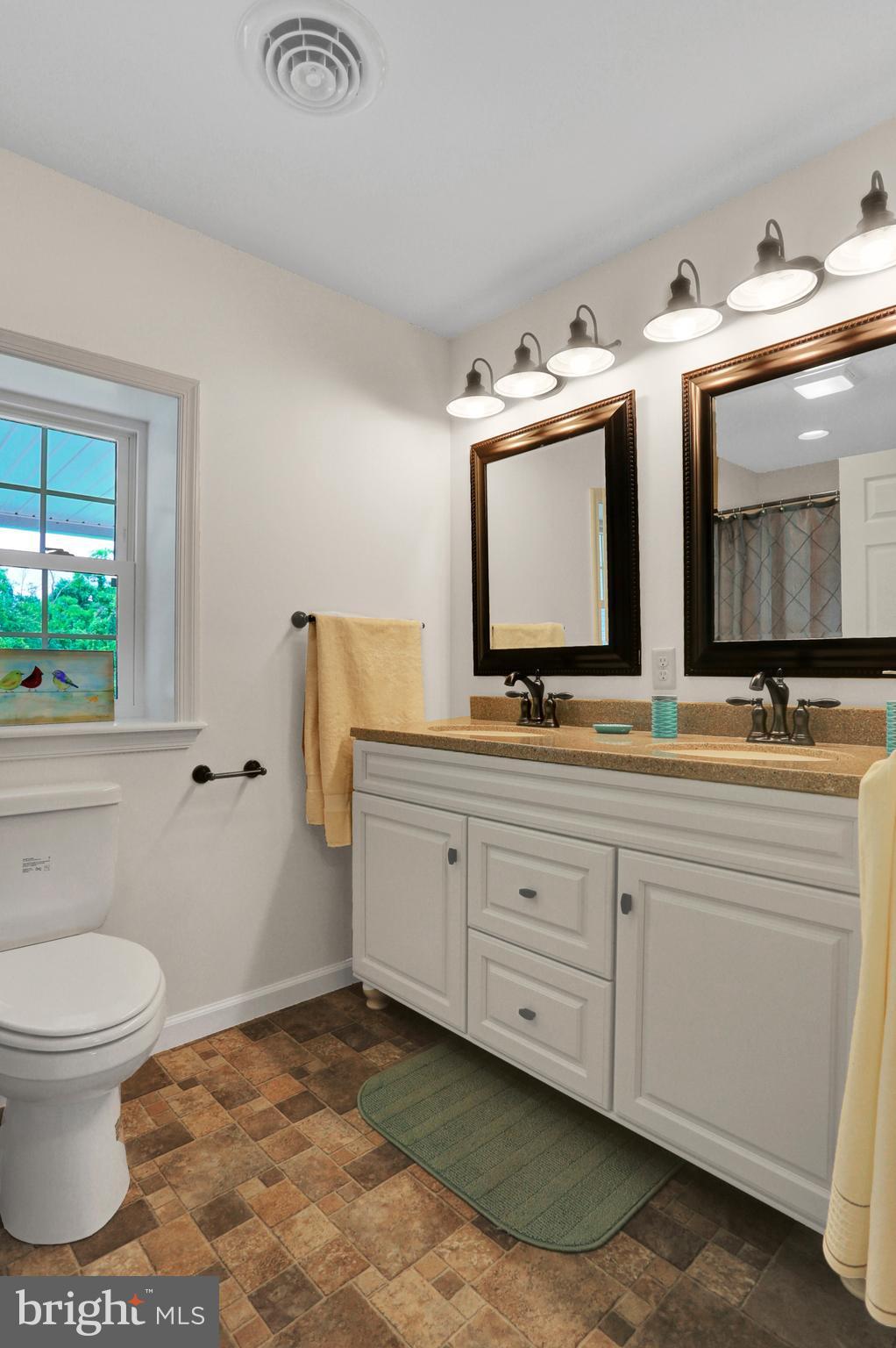 14809 Clear Spring Road Williamsport, MD 21795 - Photo 11 of 27 a bathroom with double sink and a mirror