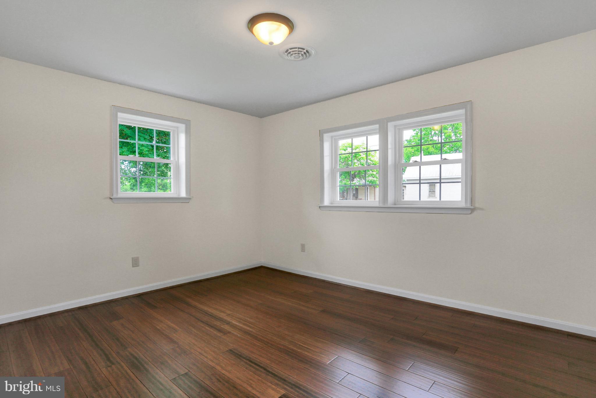 14809 Clear Spring Road Williamsport, MD 21795 - Photo 15 of 27 an empty room with wooden floor and windows
