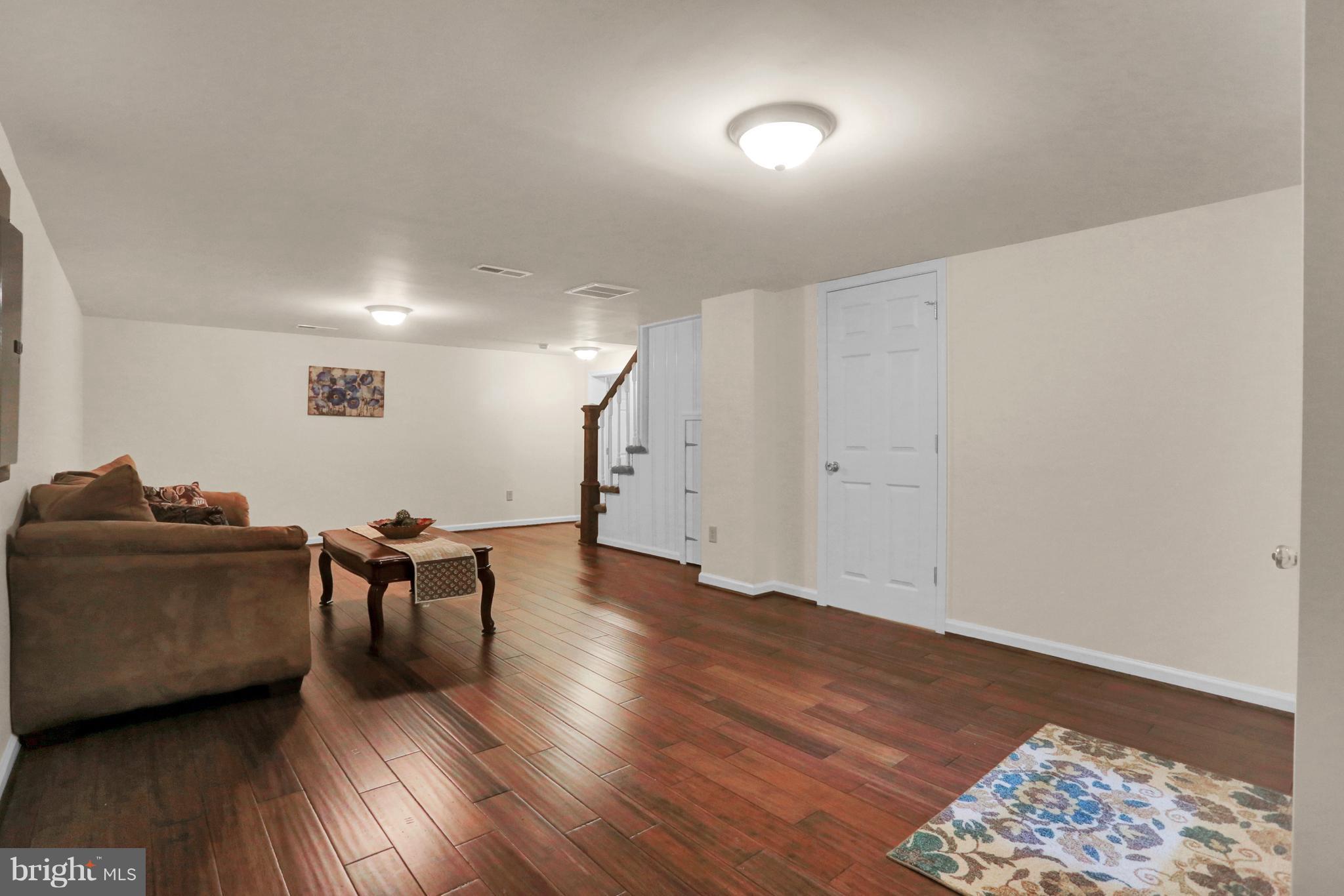 14809 Clear Spring Road Williamsport, MD 21795 - Photo 17 of 27 a living room with furniture and a wooden floor