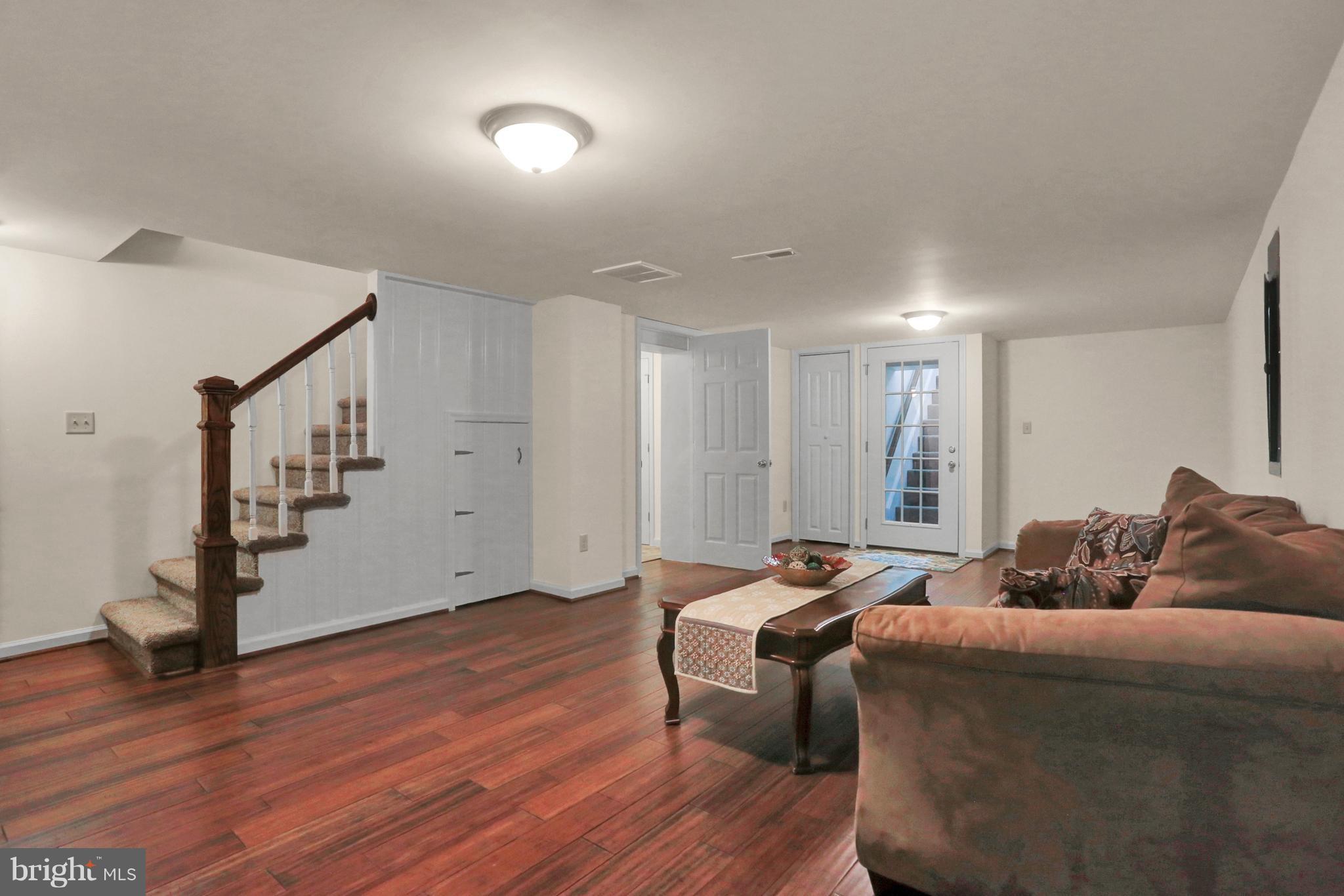 14809 Clear Spring Road Williamsport, MD 21795 - Photo 18 of 27 a living room with furniture and a wooden floor