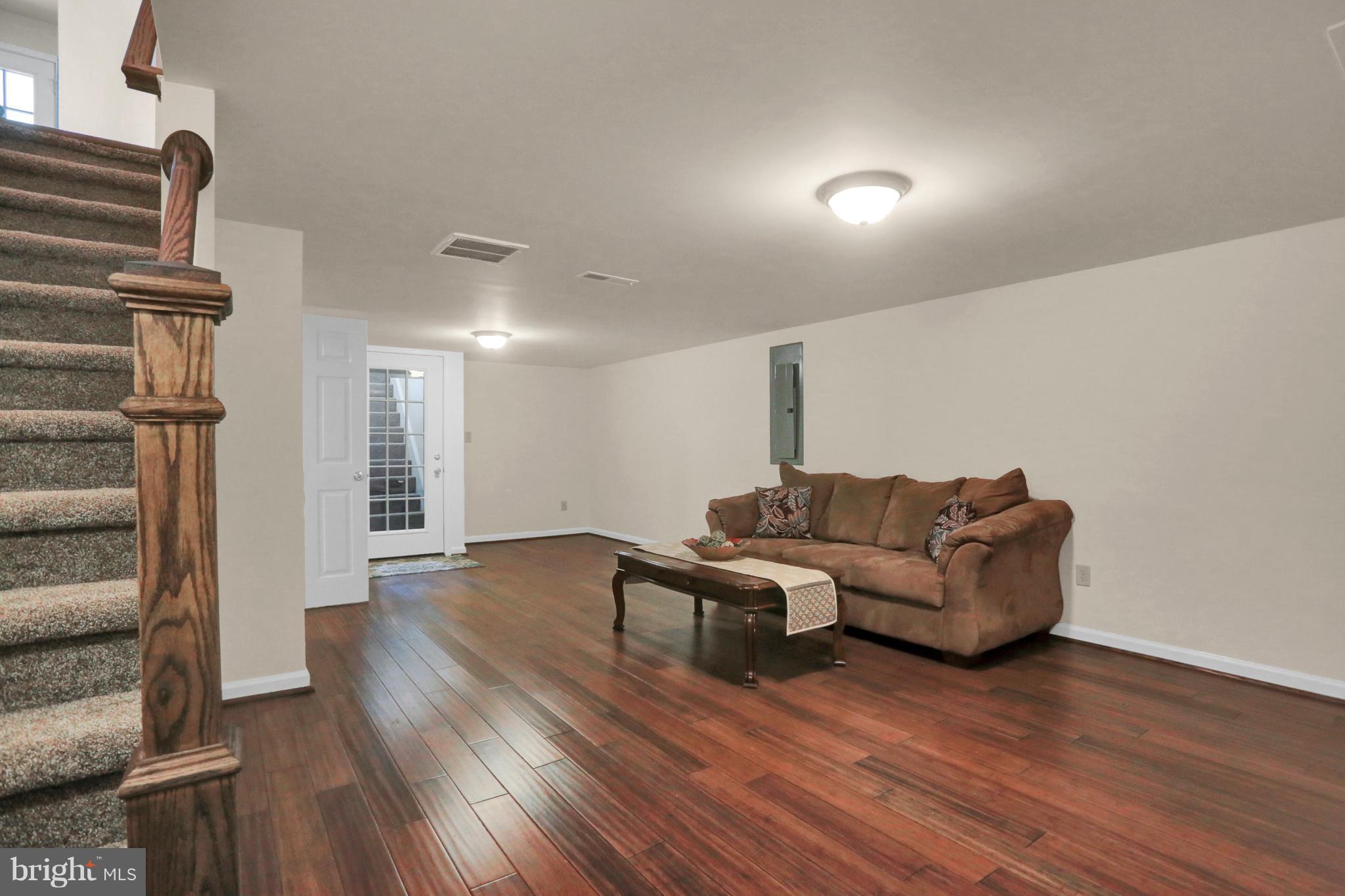 14809 Clear Spring Road Williamsport, MD 21795 - Photo 19 of 27 a living room with furniture and a wooden floor