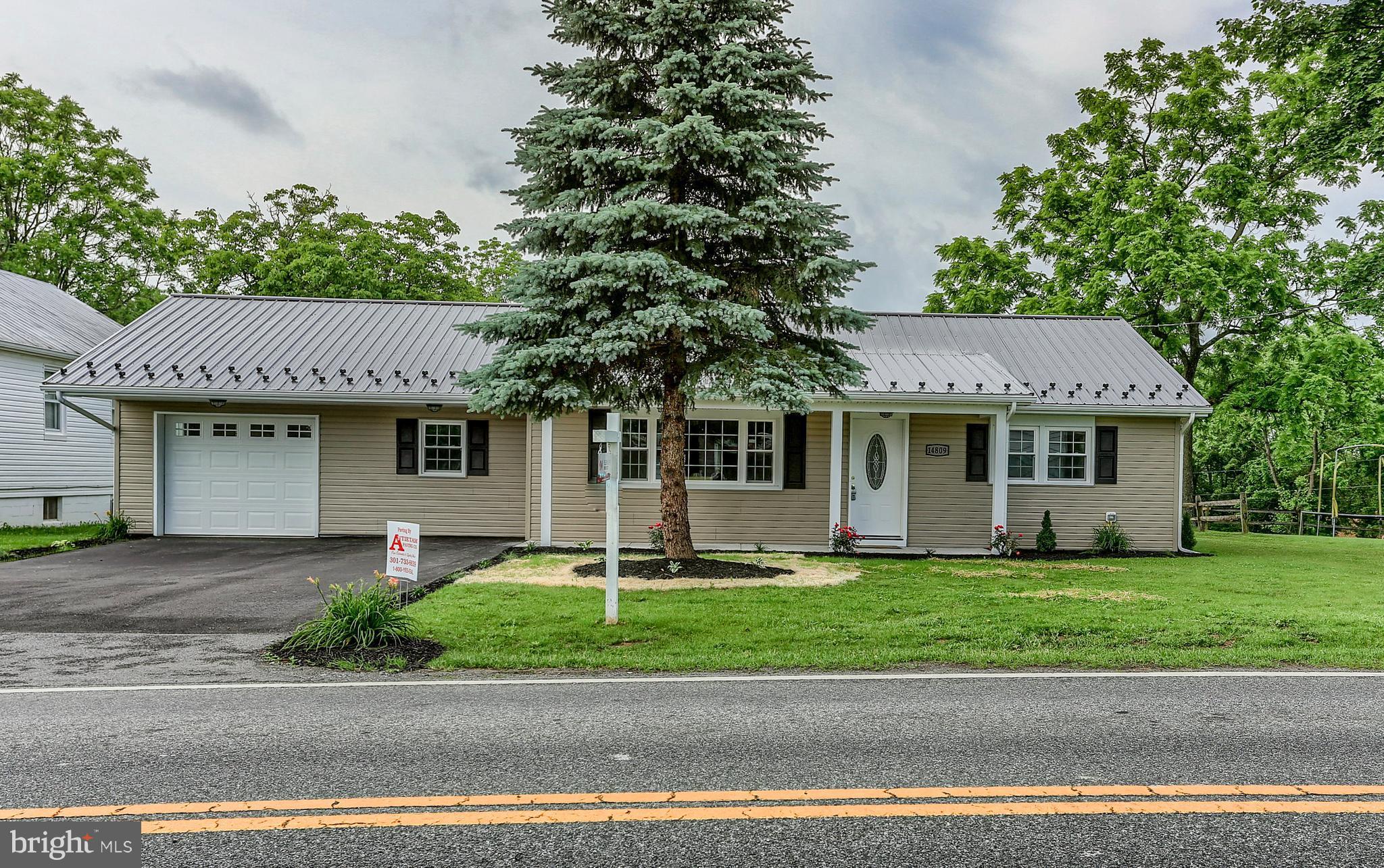 14809 Clear Spring Road Williamsport, MD 21795 - Photo 3 of 27 a front view of a house with a garden and trees