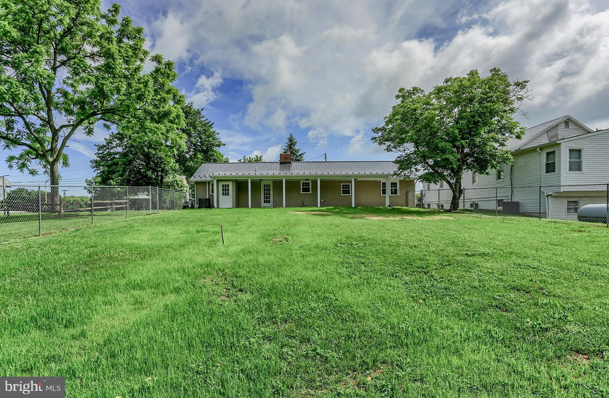 14809 Clear Spring Road Williamsport, MD 21795 - Photo 26 of 27 a front view of a house with a garden