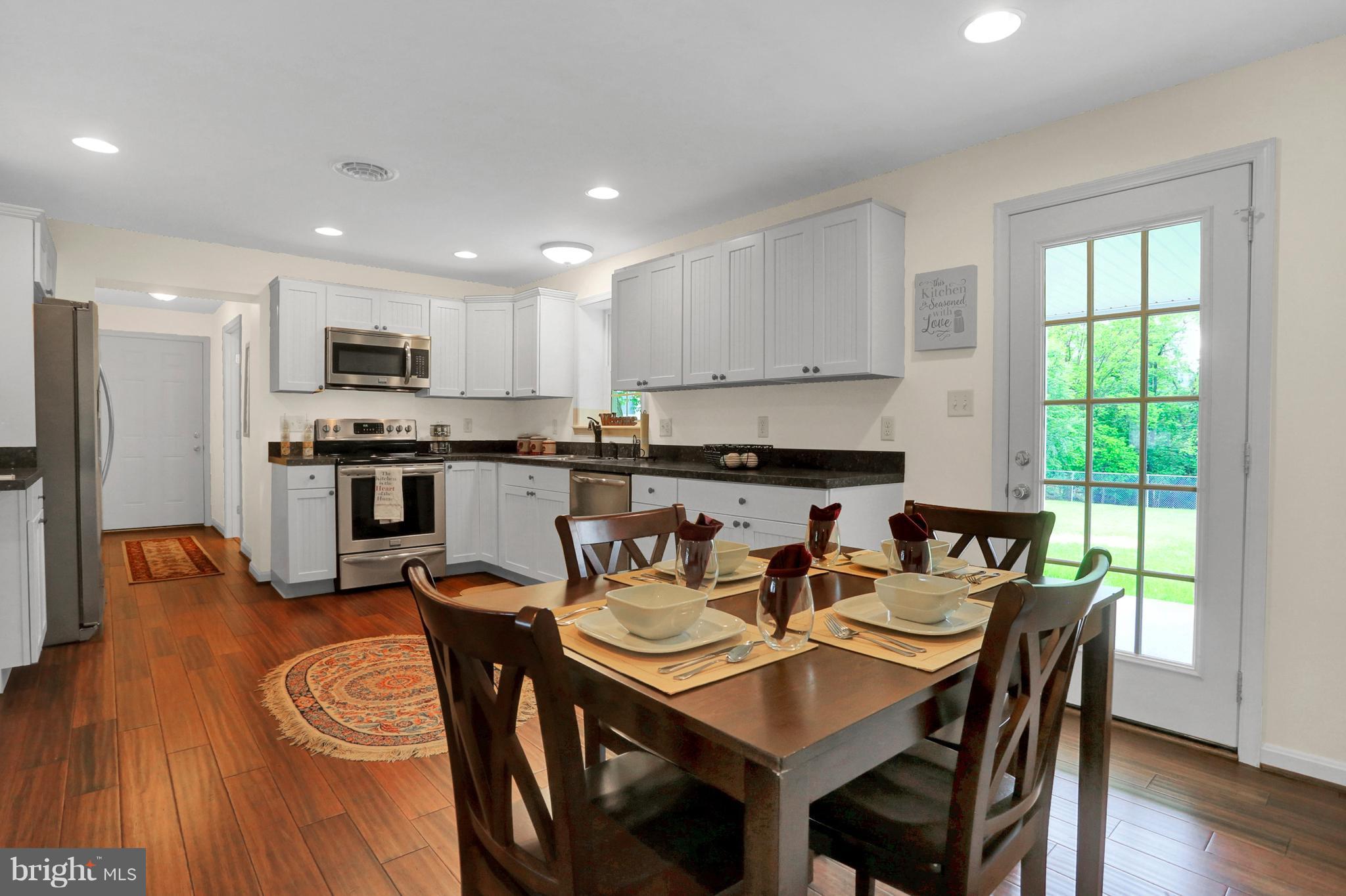14809 Clear Spring Road Williamsport, MD 21795 - Photo 8 of 27 a view of a dining room with furniture and wooden floor