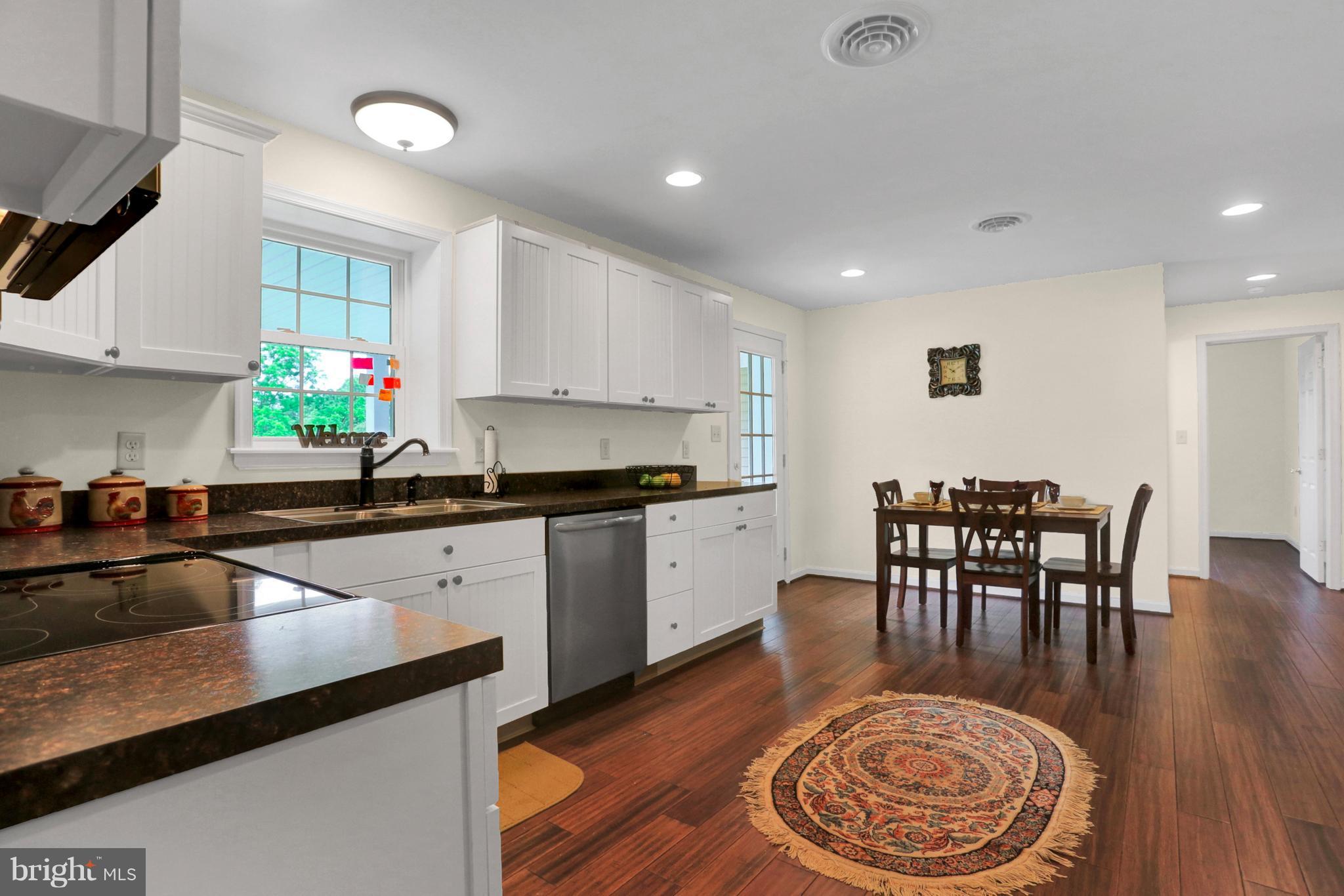 14809 Clear Spring Road Williamsport, MD 21795 - Photo 9 of 27 a kitchen with stainless steel appliances granite countertop a table chairs sink and cabinets
